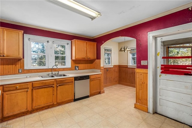 kitchen with sink, ornamental molding, stainless steel dishwasher, a chandelier, and pendant lighting