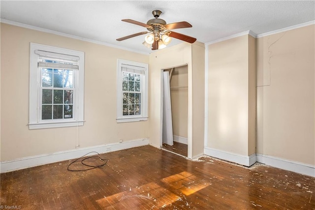 unfurnished bedroom with ceiling fan, crown molding, a closet, and dark hardwood / wood-style floors