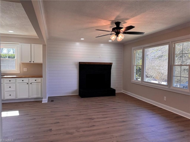 unfurnished living room featuring dark wood-style floors and crown molding