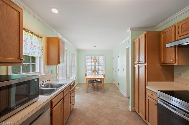 kitchen featuring appliances with stainless steel finishes, a sink, baseboards, light countertops, and light floors