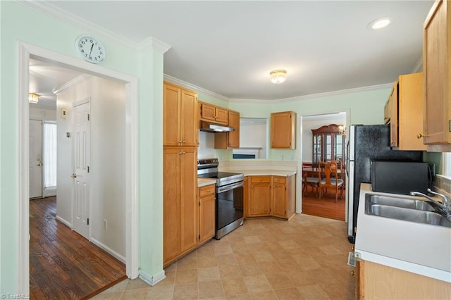 kitchen featuring light countertops, crown molding, appliances with stainless steel finishes, and a sink