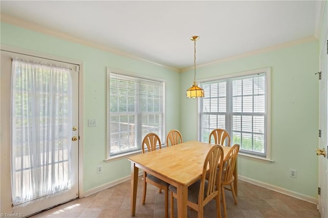 dining space featuring crown molding, baseboards, and light tile patterned floors