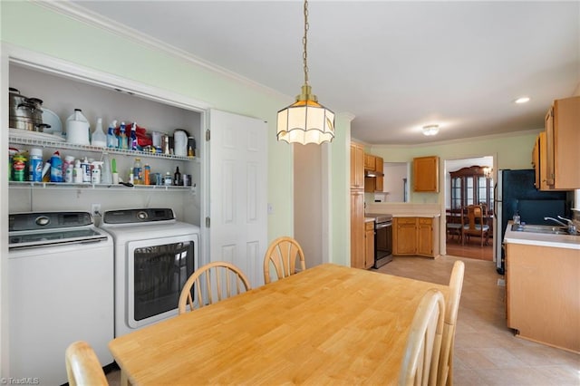 dining room featuring washer and dryer and crown molding