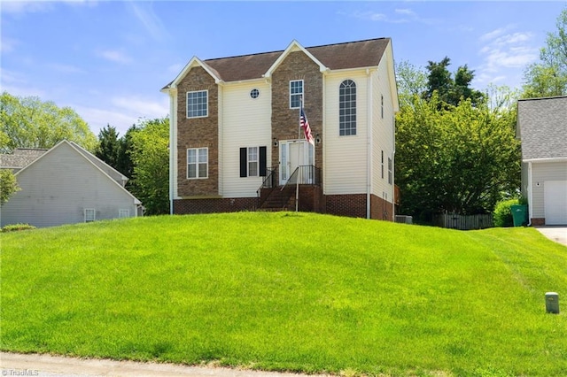 view of front of home with a front yard and a garage