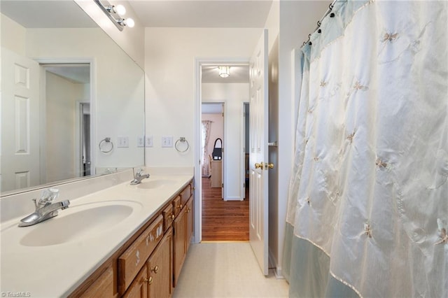 bathroom with a sink and double vanity