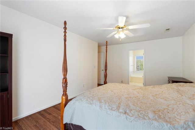 bedroom featuring visible vents, wood finished floors, baseboards, ceiling fan, and ensuite bath