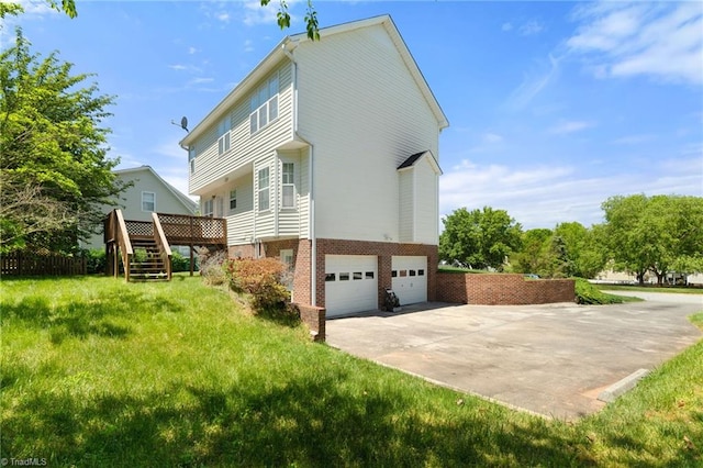 view of home's exterior with stairs, brick siding, a garage, a wooden deck, and driveway