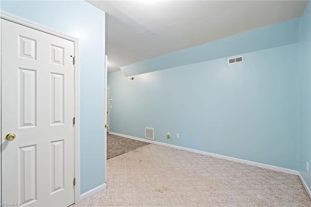 unfurnished room featuring baseboards, carpet, and visible vents