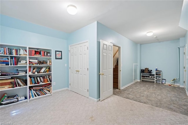 miscellaneous room with carpet floors and baseboards