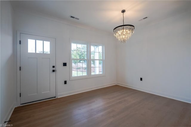 entrance foyer with visible vents, baseboards, dark wood-type flooring, and a notable chandelier