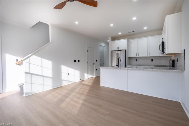 kitchen featuring white cabinets, appliances with stainless steel finishes, a peninsula, and ceiling fan