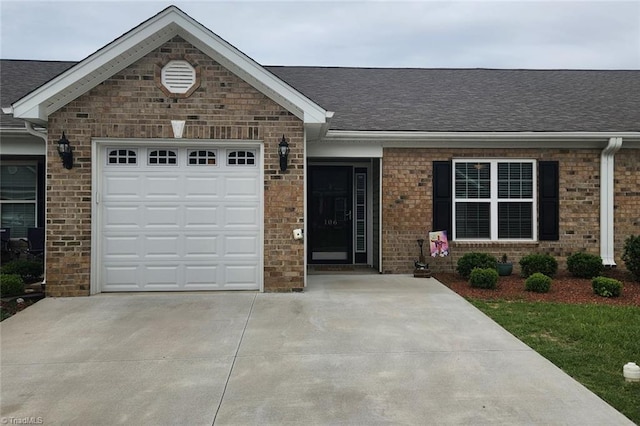 106 Oak Ridge Dr, Archdale, NC 27263 - ranch-style house featuring concrete driveway, an attached garage, roof with shingles, and brick siding