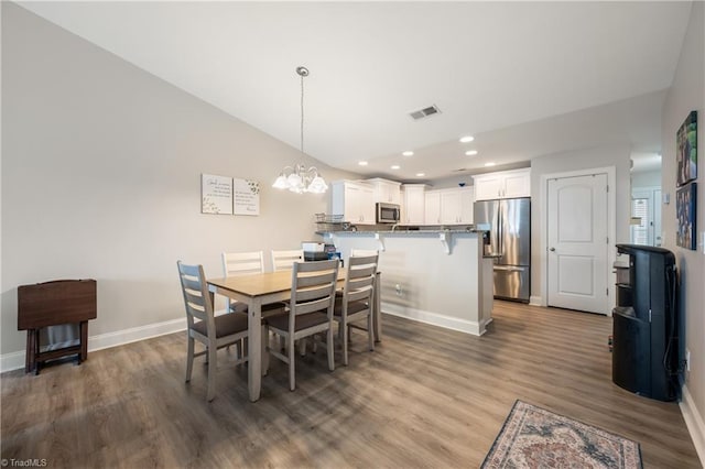 106 Oak Ridge Dr, Archdale, NC 27263 - dining space with baseboards, a chandelier, recessed lighting, wood finished floors, and vaulted ceiling