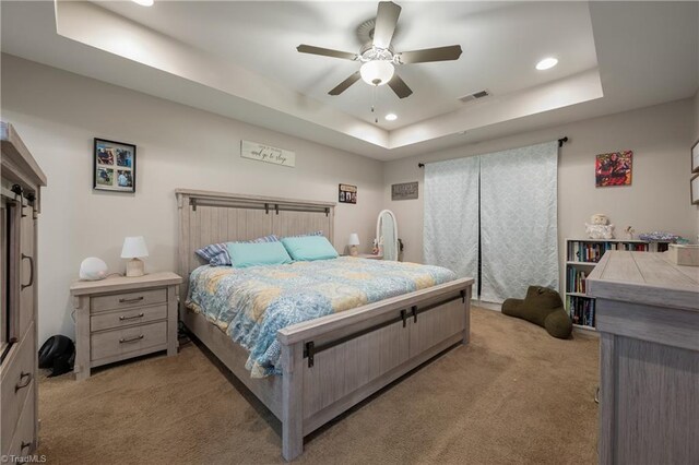 106 Oak Ridge Dr, Archdale, NC 27263 - bedroom with light carpet, a tray ceiling, recessed lighting, a barn door, and ceiling fan