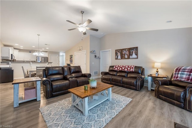 106 Oak Ridge Dr, Archdale, NC 27263 - living area featuring vaulted ceiling, ceiling fan, light wood-style floors, a chandelier, and baseboards