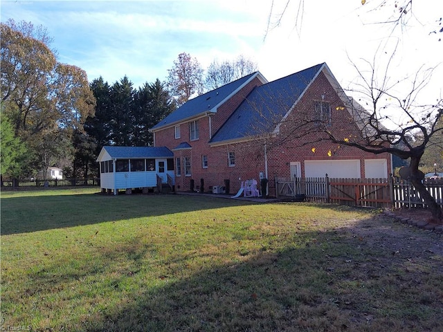 exterior space with a sunroom and a yard