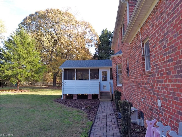 view of front facade featuring a sunroom and a front lawn