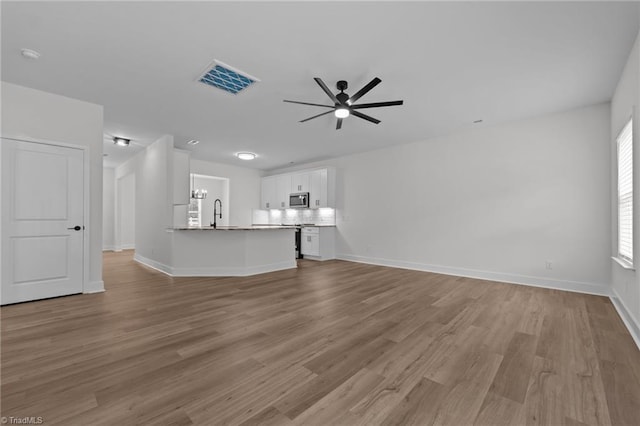 1329 Union Cross Rd, Kernersville, NC 27284 - unfurnished living room with ceiling fan, wood finished floors, and baseboards