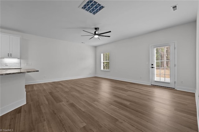 1329 Union Cross Rd, Kernersville, NC 27284 - unfurnished living room with healthy amount of natural light, ceiling fan, dark wood-style flooring, and baseboards