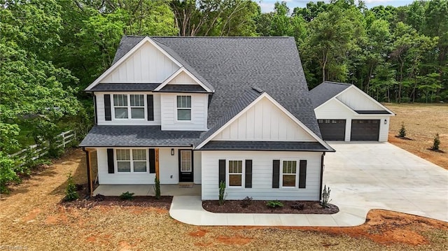 1329 Union Cross Rd, Kernersville, NC 27284 - view of front of home featuring board and batten siding, driveway, roof with shingles, and a porch