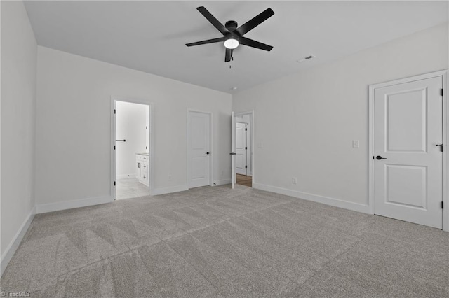 1329 Union Cross Rd, Kernersville, NC 27284 - unfurnished bedroom with light colored carpet, baseboards, ensuite bath, and a ceiling fan