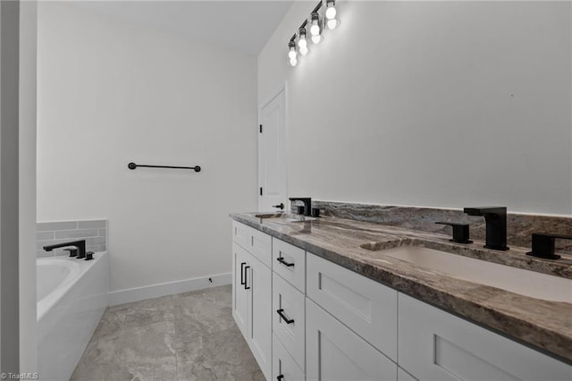 1329 Union Cross Rd, Kernersville, NC 27284 - bathroom with double vanity, a tub, baseboards, and marble finish floors