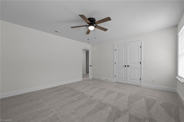 1329 Union Cross Rd, Kernersville, NC 27284 - unfurnished bedroom featuring light colored carpet, baseboards, a ceiling fan, and a closet