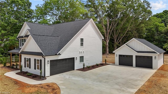 1329 Union Cross Rd, Kernersville, NC 27284 - view of home's exterior featuring roof with shingles, a detached garage, an outdoor structure, and board and batten siding