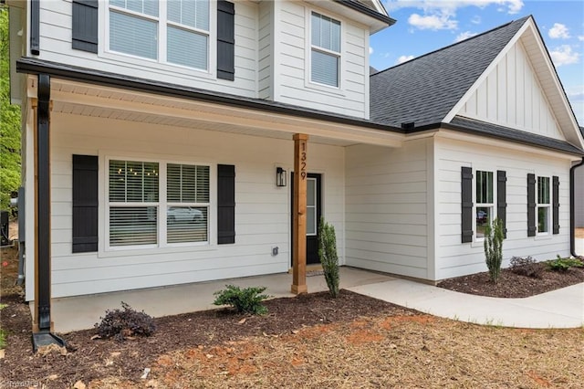 1329 Union Cross Rd, Kernersville, NC 27284 - view of front of home with covered porch, roof with shingles, and board and batten siding