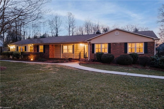 ranch-style house with a yard