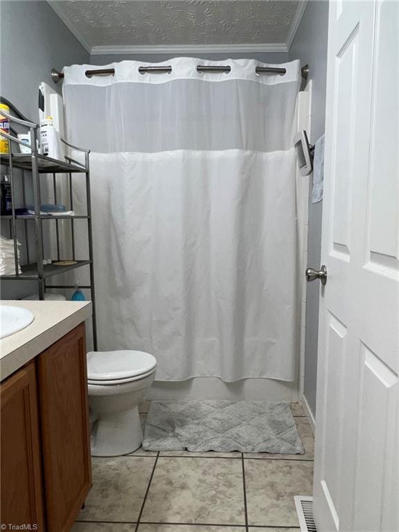 bathroom featuring vanity, crown molding, toilet, and a textured ceiling