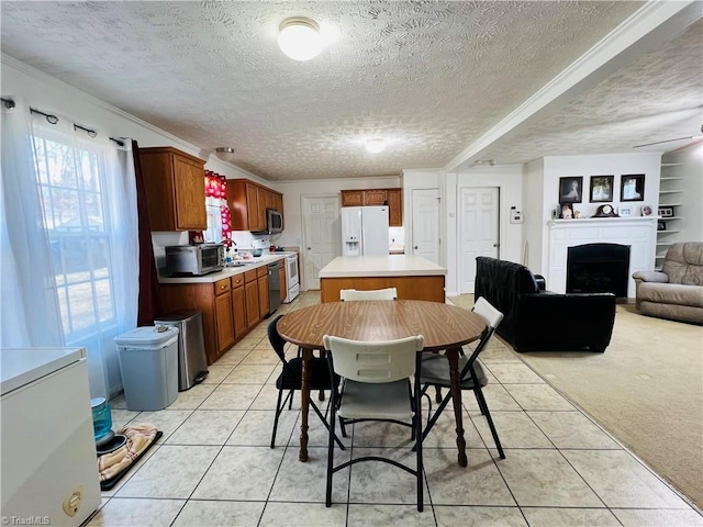 dining area with light carpet, built in shelves, and a textured ceiling