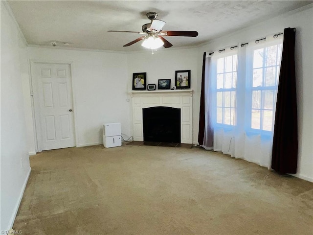 unfurnished living room with crown molding, light colored carpet, and ceiling fan