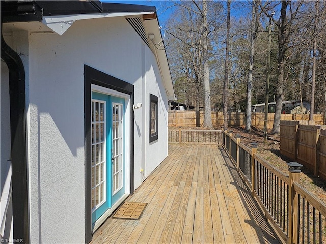 wooden deck featuring french doors and fence