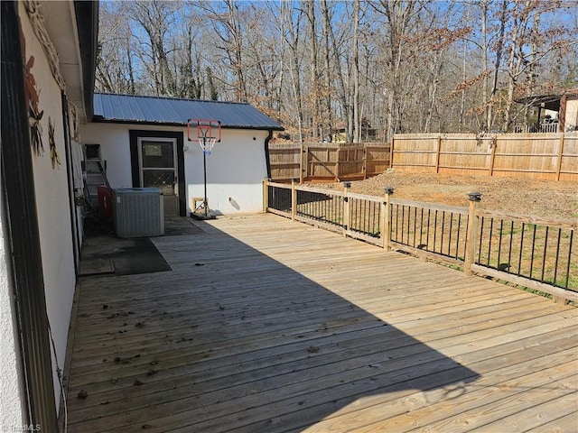 wooden terrace featuring central AC and fence