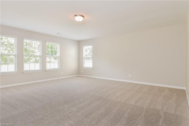 empty room featuring light carpet