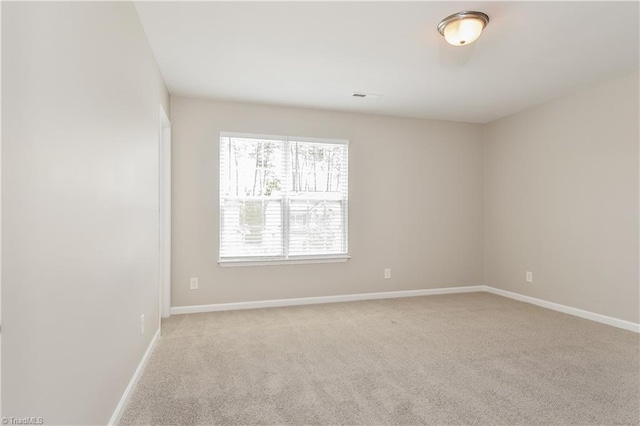 unfurnished room featuring light carpet