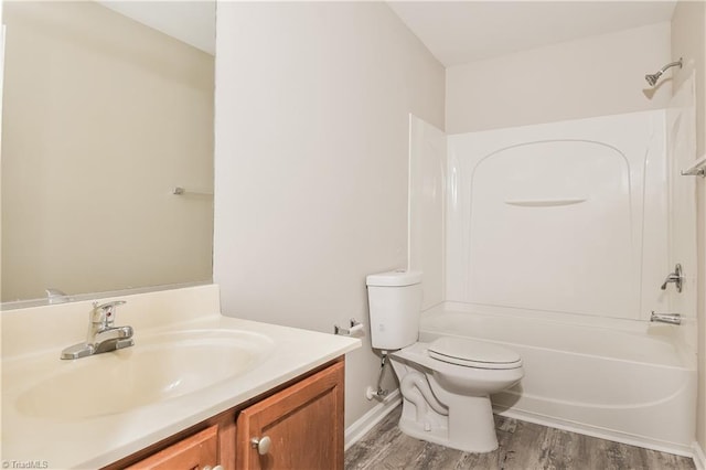 full bathroom with hardwood / wood-style floors, vanity, toilet, and shower / washtub combination