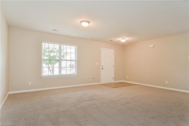 empty room featuring light colored carpet