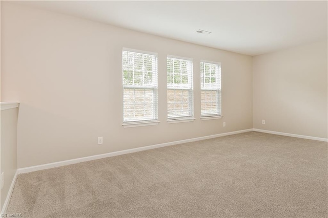 unfurnished room with light colored carpet