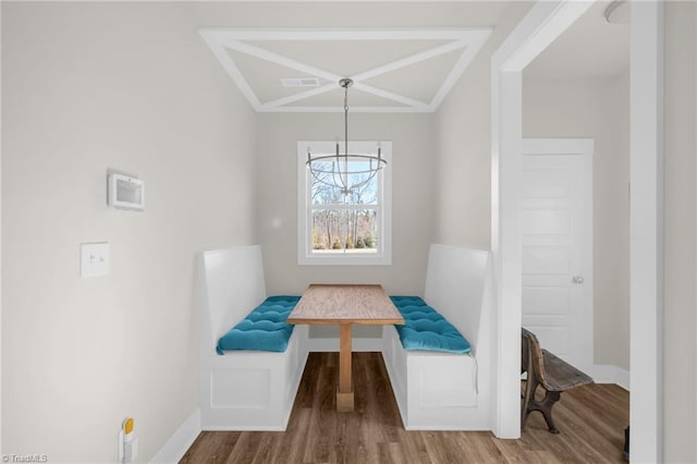 dining room featuring breakfast area, visible vents, baseboards, and wood finished floors