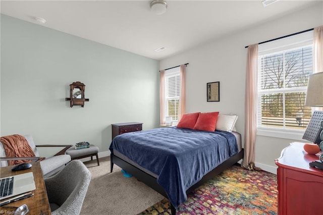 bedroom with carpet flooring, visible vents, and baseboards