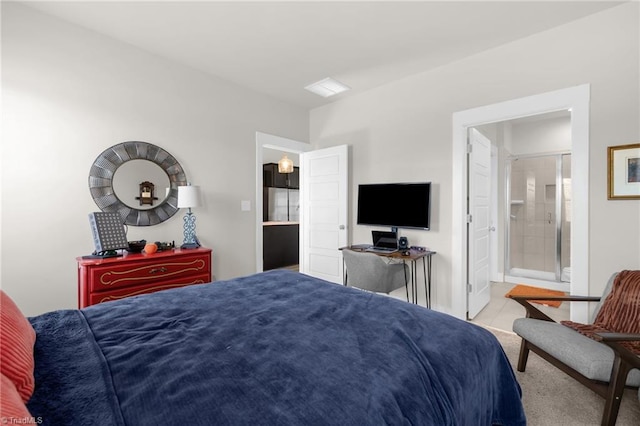 bedroom with light tile patterned floors and ensuite bathroom