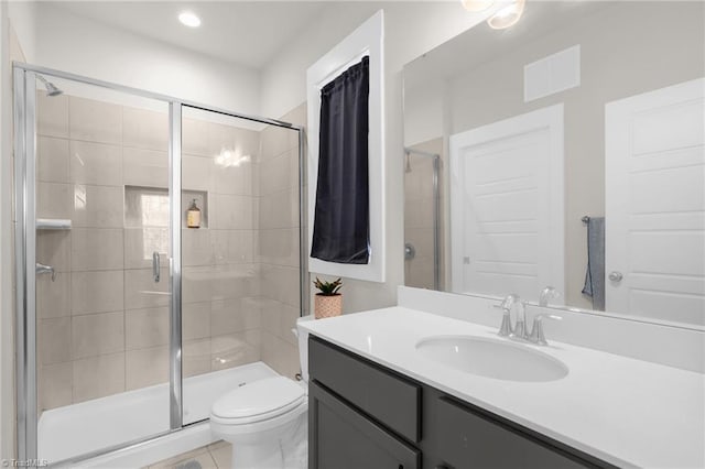 full bathroom with a stall shower, tile patterned flooring, vanity, and toilet