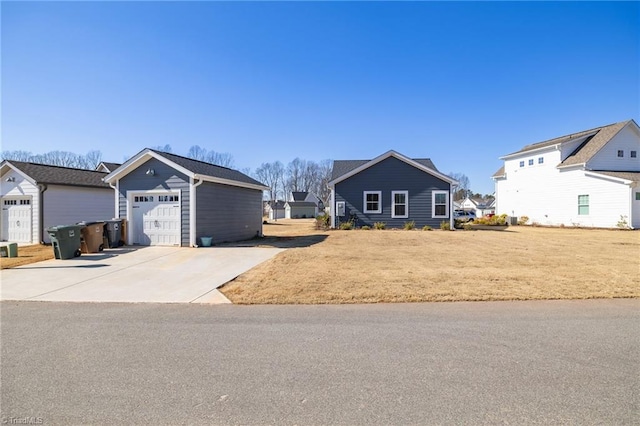 view of front of home with a garage, a residential view, and concrete driveway