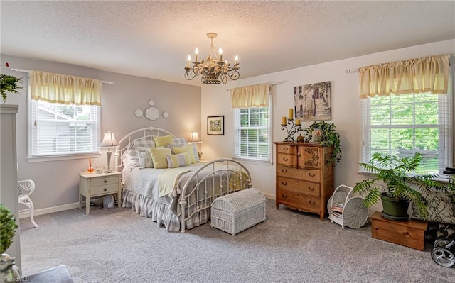 bedroom with a chandelier, carpet flooring, and a textured ceiling