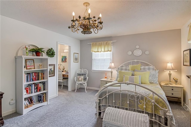 carpeted bedroom with a chandelier, baseboards, and a textured ceiling
