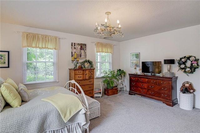 carpeted bedroom featuring a chandelier