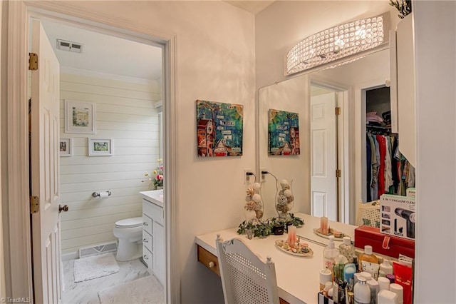 bathroom featuring vanity and toilet