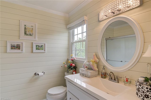 full bathroom with toilet, crown molding, vanity, an enclosed shower, and wood walls